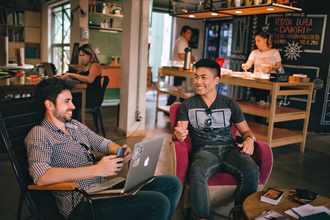 Group of seated people conversing indoors